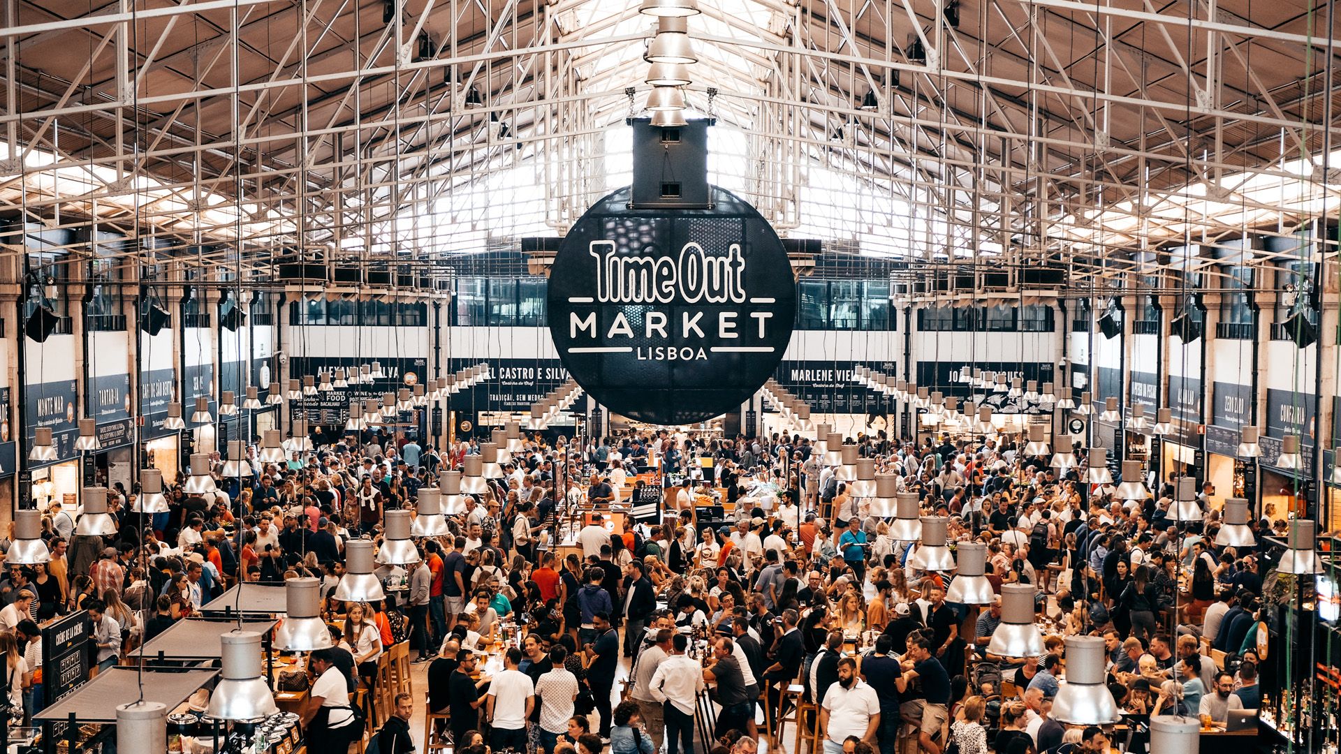 A large crowd of people are gathered in Time Out Market.