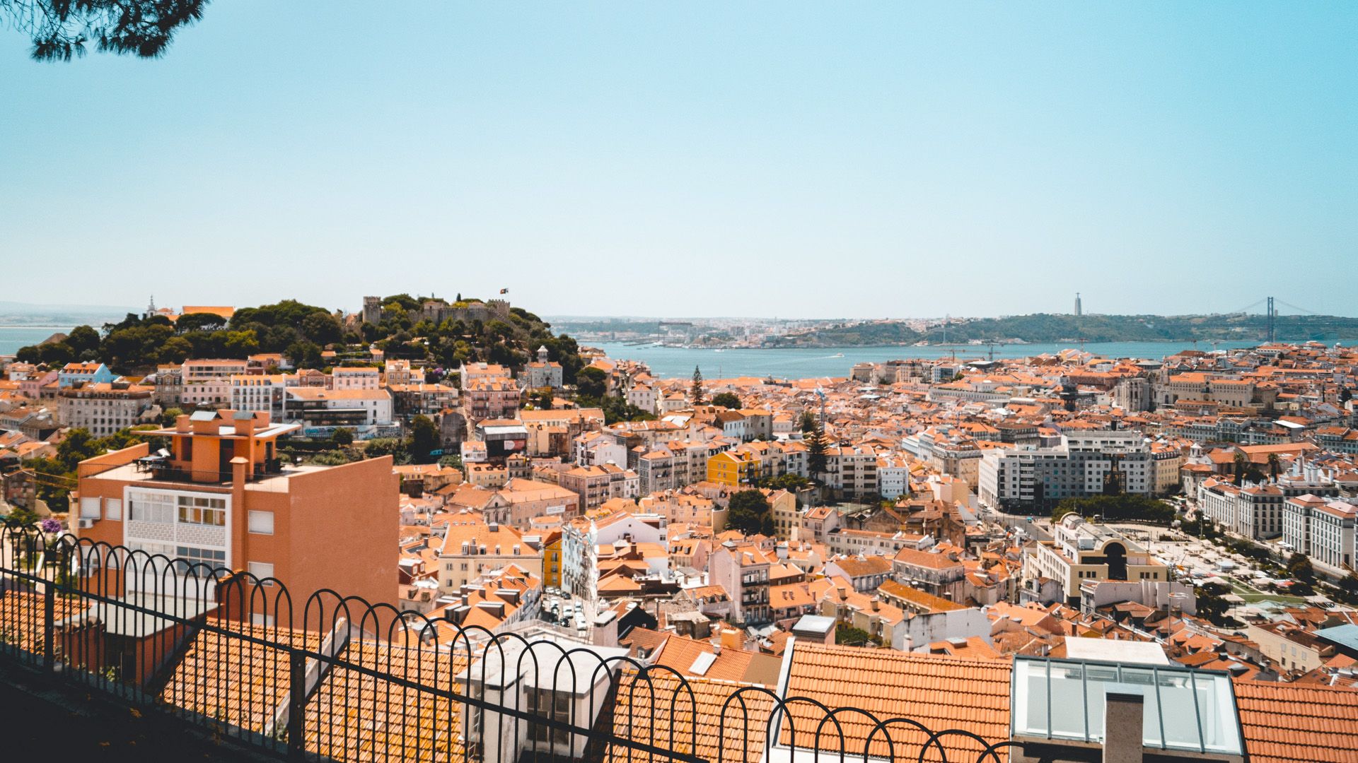 An aerial view of a city with a fence in the foreground.