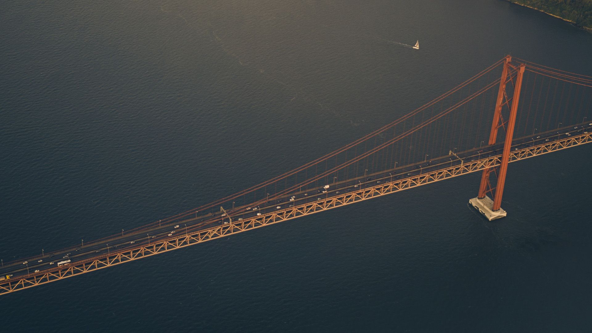 An aerial view of a bridge April 25th over a body of water.